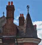Chimneys and spires on top of The Crown in Plaistow Lane.